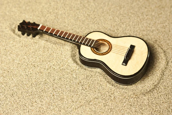 Spanish guitar in the sand