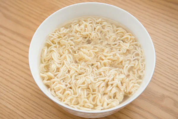 Bowl of instant noodles on a wood table