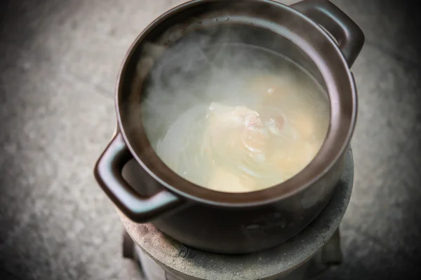 Cooking soup with coal briquette oven