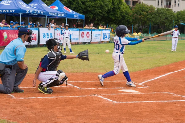 ZHONGSHAN PANDA CUP, ZHONGSHAN, GUANGDONG - July 23:batter of team Zhongshan TongMao Primary School missed the ball during a match of 2015 National Baseball Championship Group A of Panda Cup against WenZhou XinTianYuan Primary School on July 23, 2015