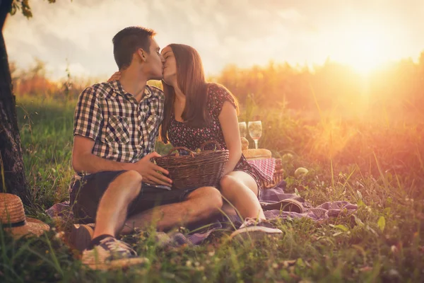 Attractive Couple Enjoying Romantic Sunset Picnic in the Countryside.