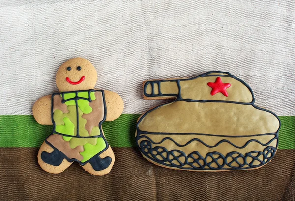 Homemade Gingerbread man in protective khaki uniforms and the ta