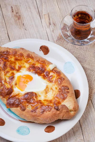 Ajarian khachapuri (traditional Georgian cheese pastry) with bak