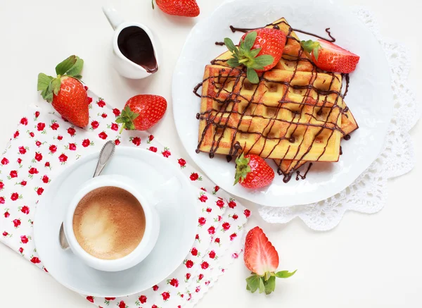 Belgium waffles with strawberries and chocolate decoration on pl