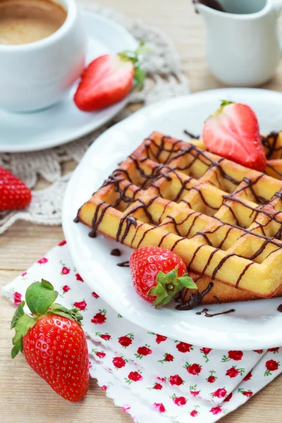 Belgium waffles with strawberries and chocolate decoration on pl