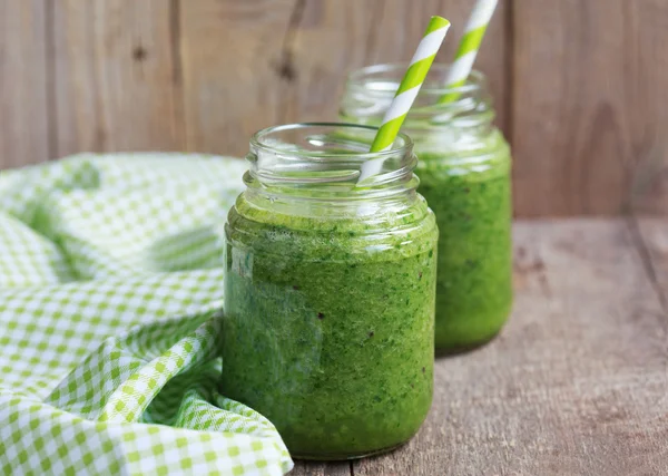 Healthy green smoothie made from spinach, kiwi, bananas and oran