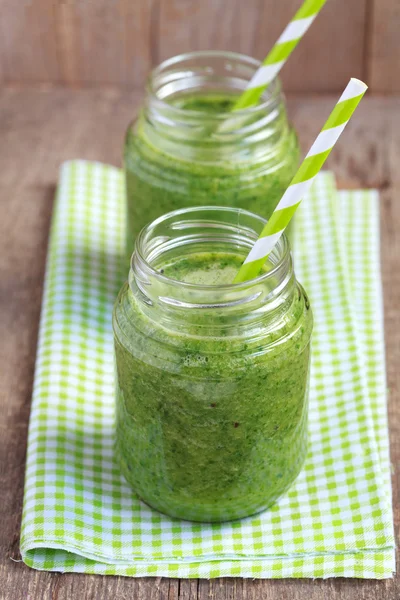 Healthy green smoothie made from spinach, kiwi, bananas and oran