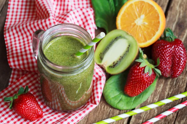 Healthy green smoothie made from spinach, kiwi, strawberries and