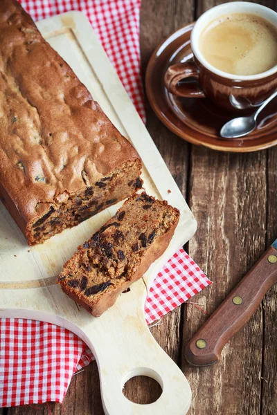 Cake with prunes and almond flour on a wooden table with a green