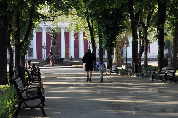 A man and a boy on a morning jog