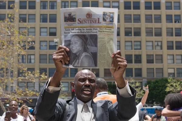 Black lives matter protestor holding a magazine during march on