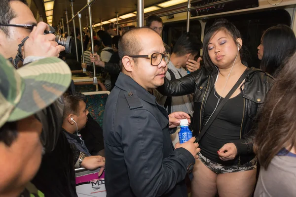 A woman without pants on the subway during the  