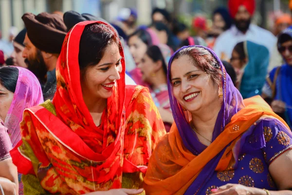 Devotee Sikhs women smiling and  marching