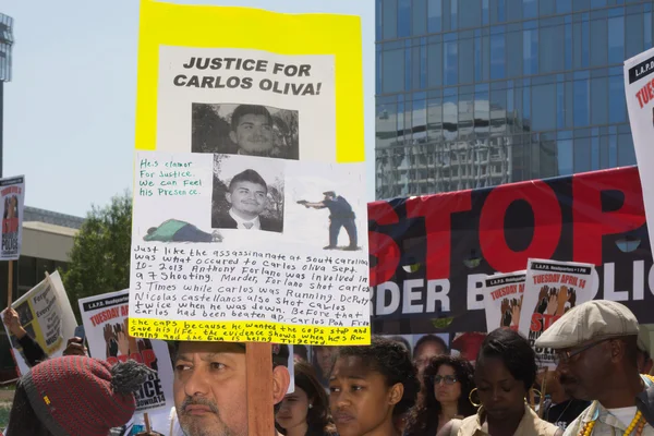 Latino man holding sign for justice