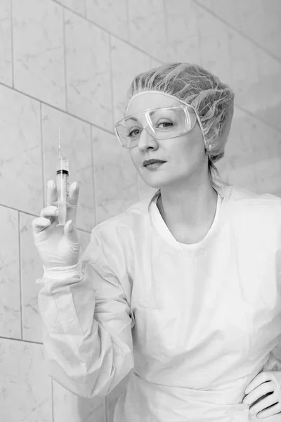Monochrome playful nurse holding syringe
