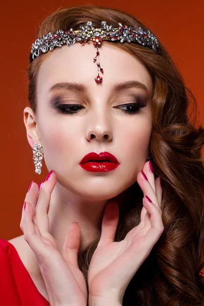 Beauty woman in red dress, red background. Red lips and nails.
