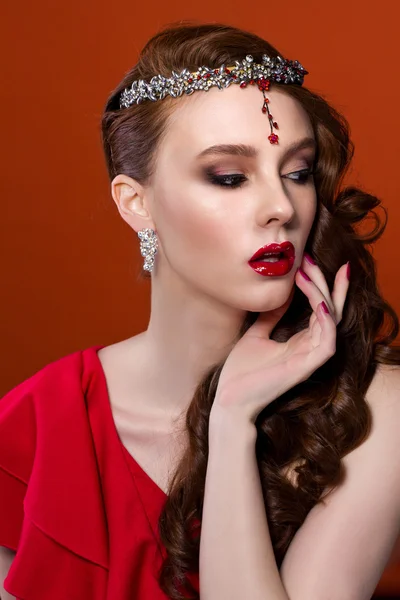 Beauty woman in red dress, red background. Red lips and nails.