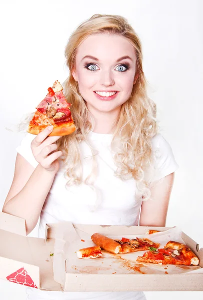 Pretty and happy  young girl eating slice of pizza and holding p