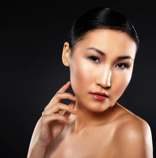 Attractive asian woman skin care image on black backgroun