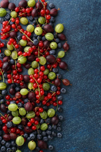 Summer berries mix on stone background.