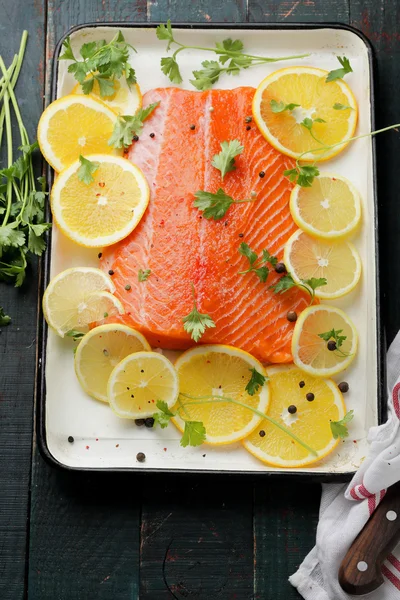 Fresh trout with citrus on baking tray