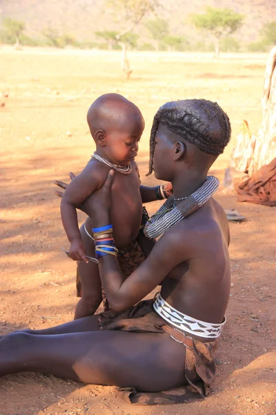 Himba girl with a children, Namibia