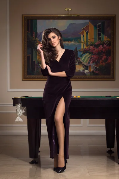 Gorgeous woman brunette wears luxury evening dress