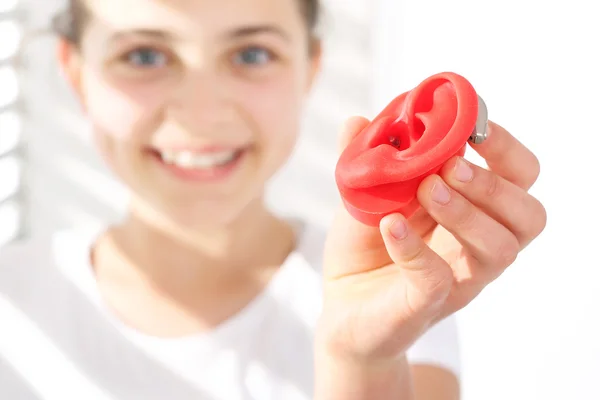 The hearing aid for a child.