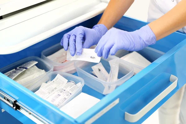 A nurse prepares an injection