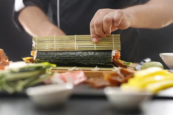 Sushi master turns sushi rolls