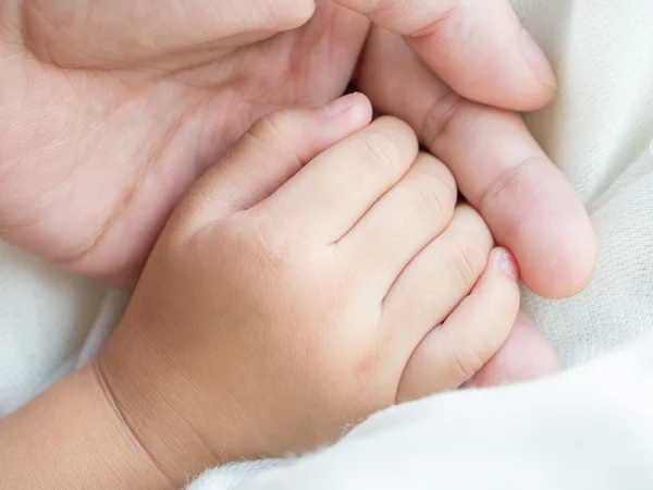 Parent and daughter holding hand