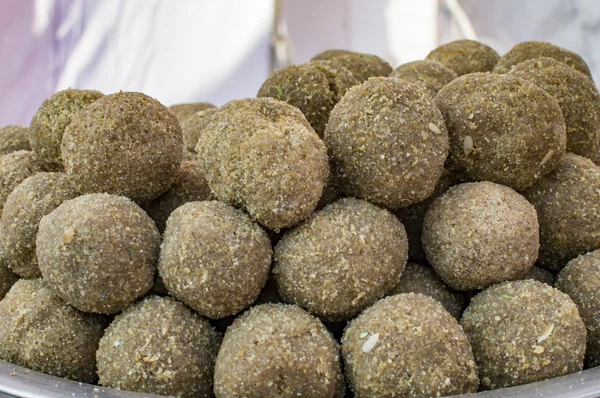 Round sweets named laddoo on display.