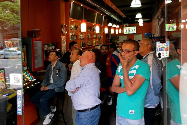 Barcelona, Spain - May 17, 2014: FC Barcelona fans watching a football match in a sports bar