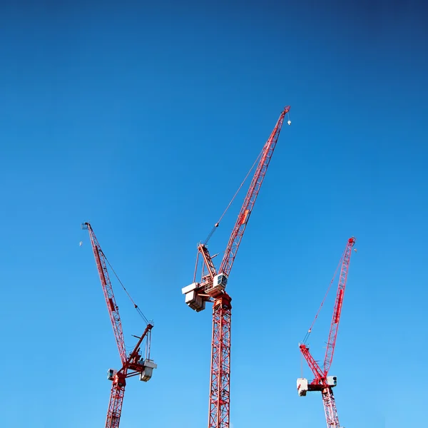 Three red cranes