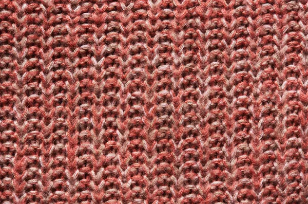 Salmon, red, orange knitted sweater texture background. Space for copy, text, lettering.