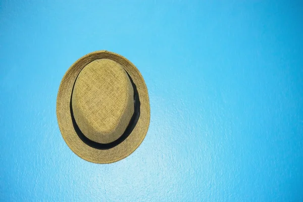 Vintage hat with black ribbon on blue