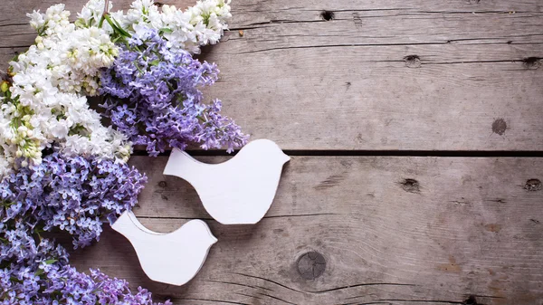 Lilac flowers and decorative birds
