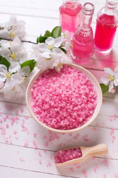 Pink sea salt in bowl and flowers