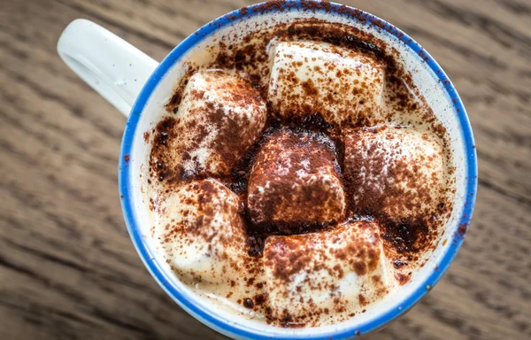 Cup of cocoa with marshmallows and cocoa powder