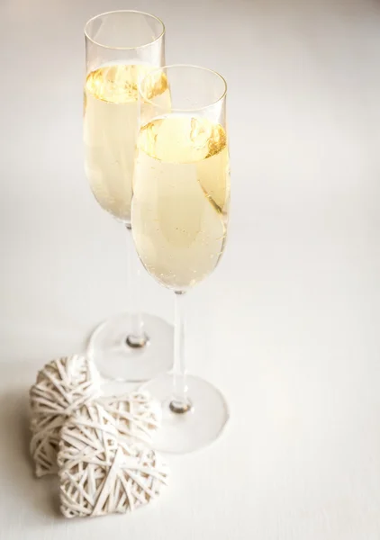 Two glasses of champagne with hearts