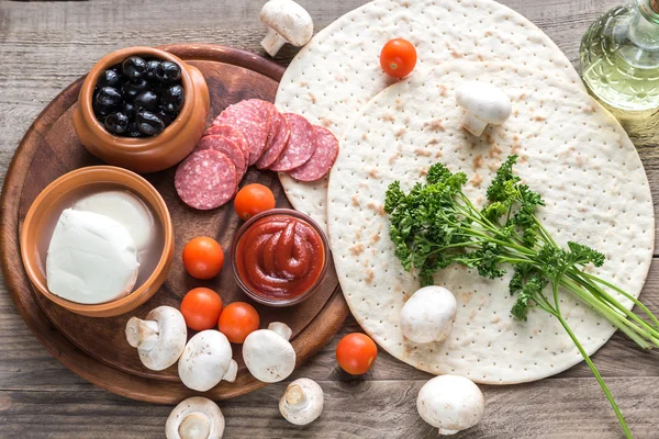 Ingredients for pizza on the wooden background