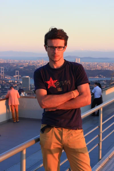 Portrait of handsome man with modern hairstyle in urban background