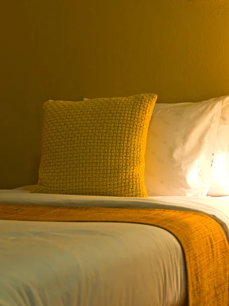 Yellow pillow in modern style bedroom interior with warm light