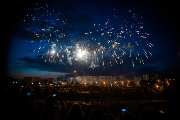 Colorful fireworks in the sky over the park in Moscow on the banks of the river