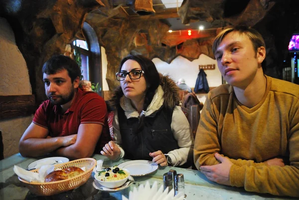 Young people having lunch at a roadside cafe while auto travel