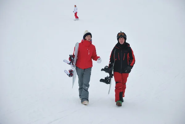 Young snowboarder and instructor descent from the mountain ski resort in Moscow