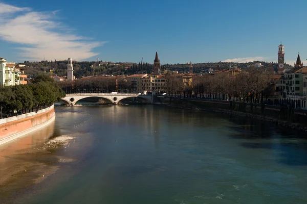 Historic buildings on the banks of the turbulent river Adige in Verona
