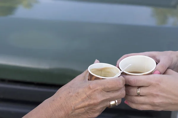 Two Hands With Coffee Cups