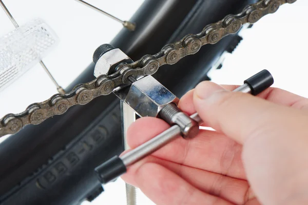 Closeup of bike chain disassembly tool
