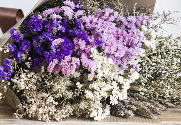 Bouquet of dried flowers on the wooden table